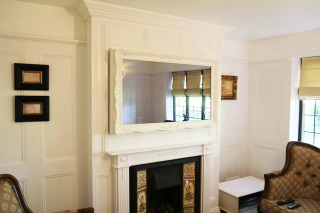 White living room interior decor with a TV after installing the Mirror TV Frame over it, seamlesly integrating the TV into decor.