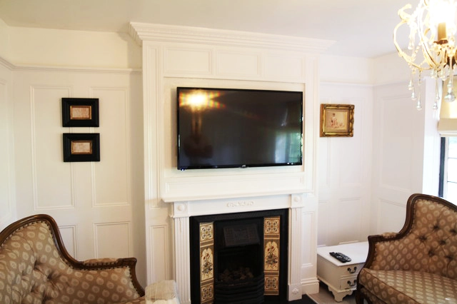 White living room interior decor with a TV before installing the Mirror TV Frame over it. 